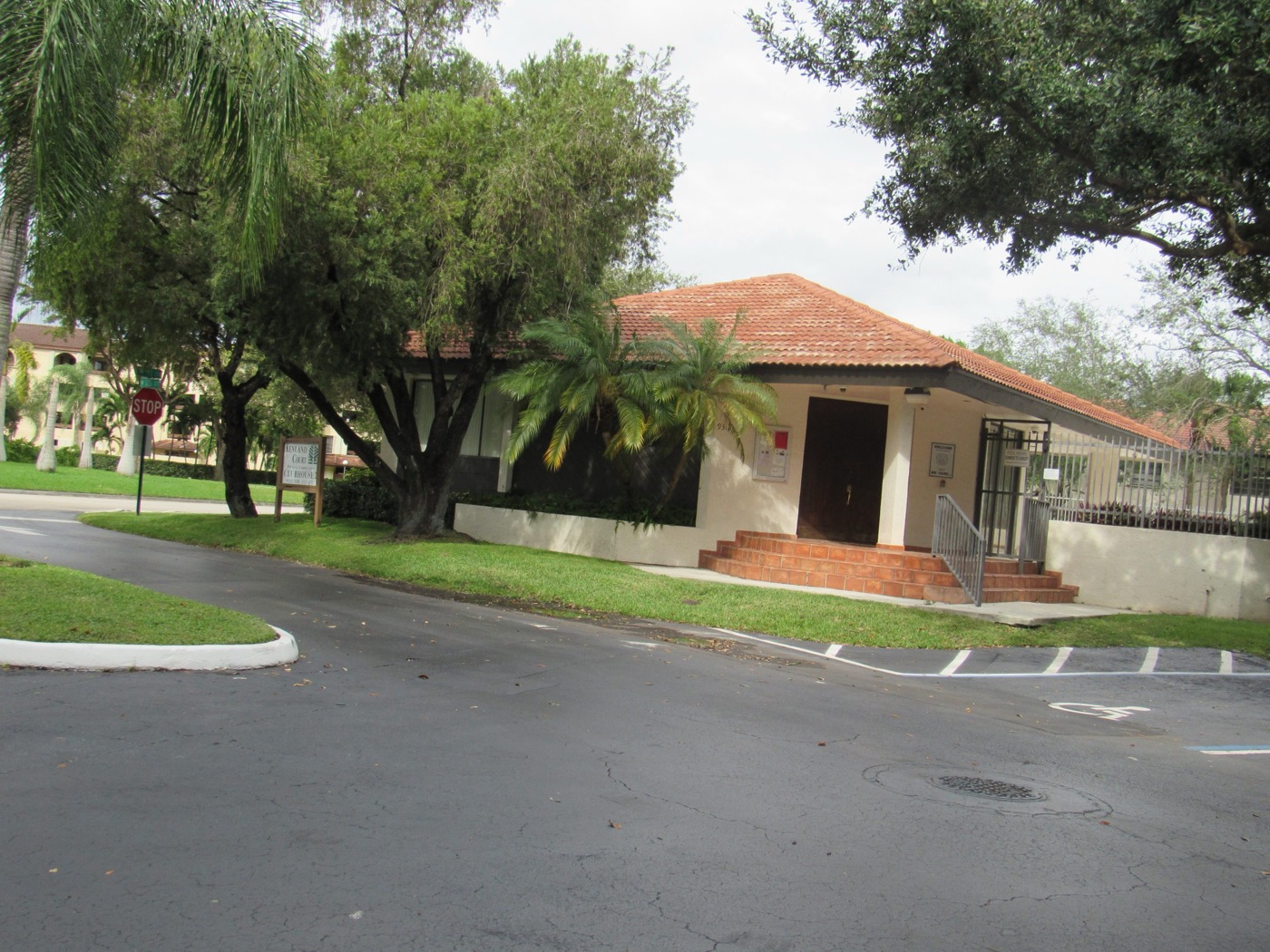 Clubhouse 2 with Spanish tile roof and palm landscaping